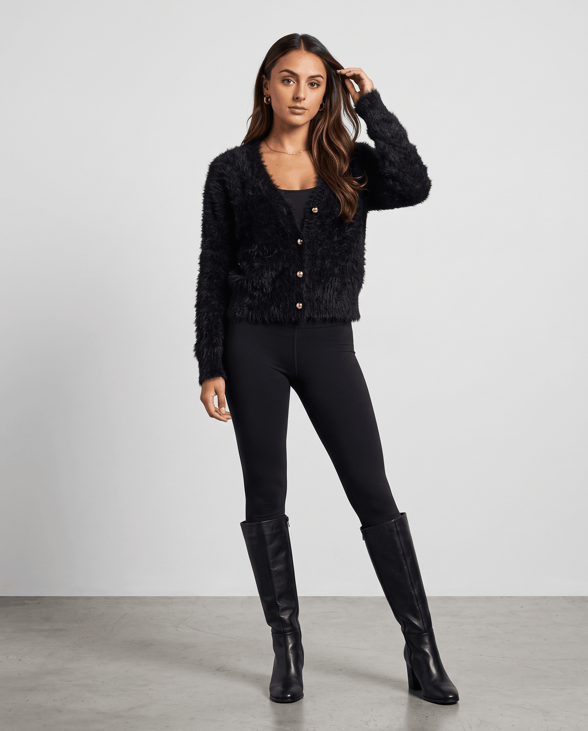 Full-length black cardigan outfit with black pants and black ankle boots
