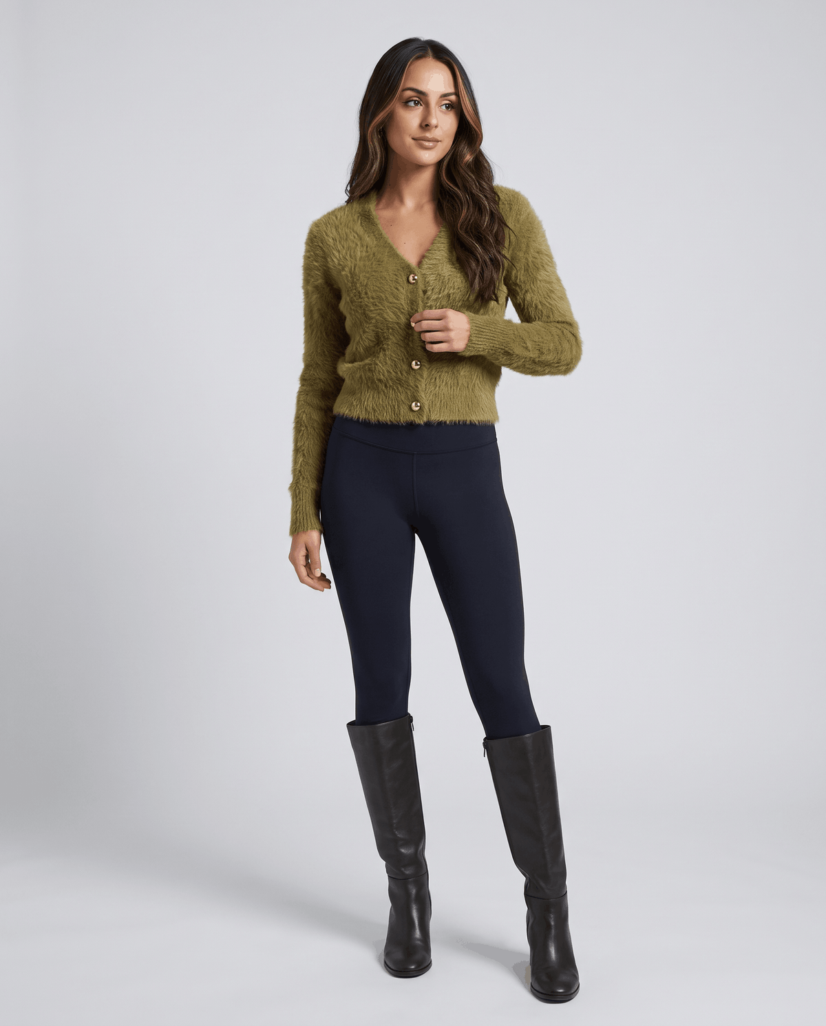 Olive green cardigan with black leggings and black knee-high boots