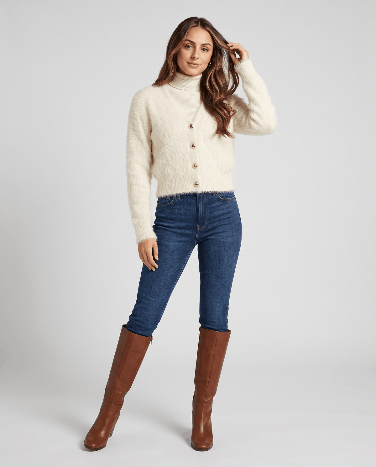 Full-length white cardigan outfit with skinny jeans and brown knee-high boots