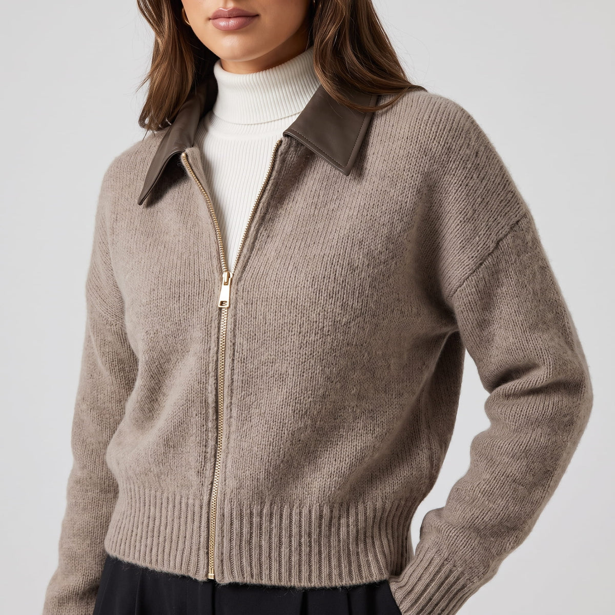 Close-up of the zip front and contrast collar worn over a white turtleneck