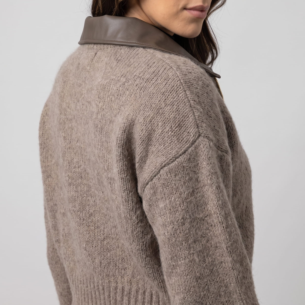Three-quarter back view of the collar and drop-shoulder seam on the knit