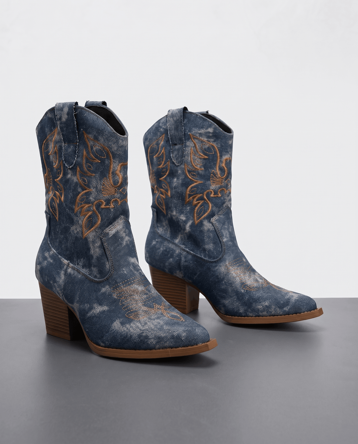 Pair of blue washed denim-look boots with golden embroidery and brown block heels