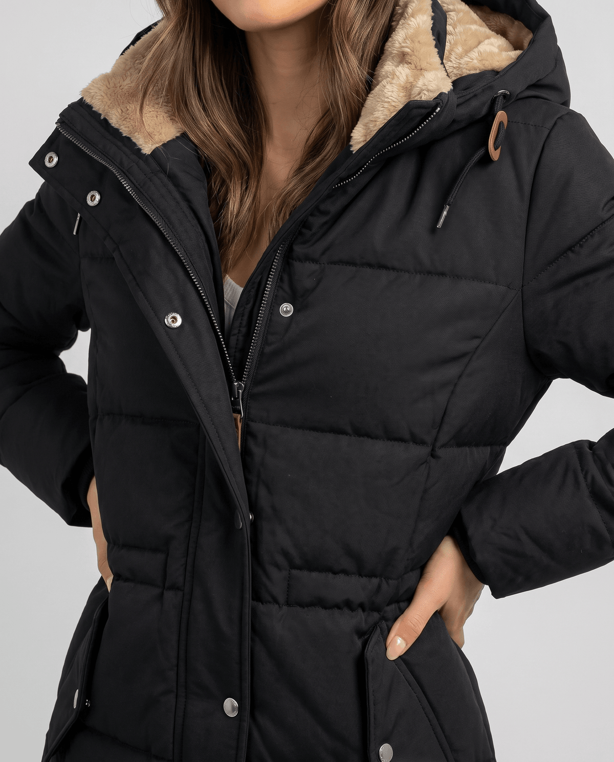 Close-up of black parka zip, snap placket and hood drawstring