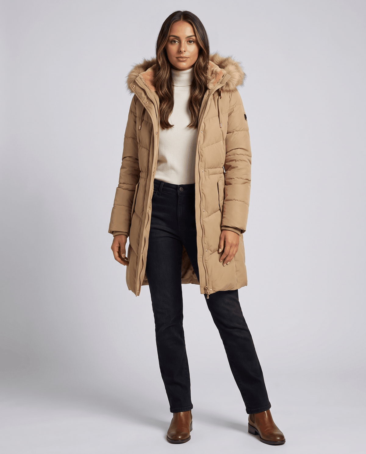 Full-length view of camel parka over a white top and black jeans