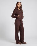 Woman in a dark brown knit full-zip jacket and drawstring straight-leg pants loungewear set, hand in pocket