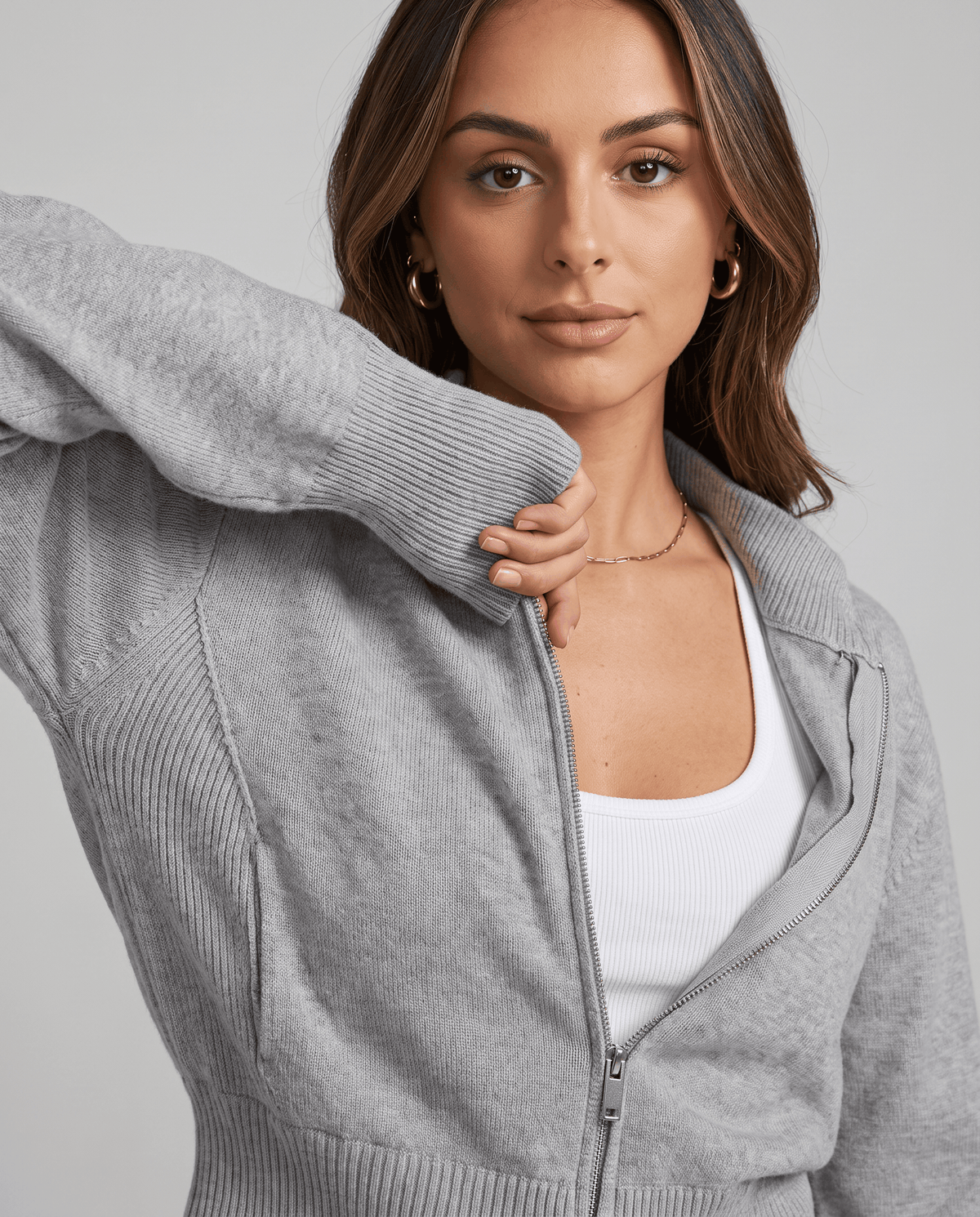 Close-up of the knit sleeve and ribbed cuff on the gray jacket