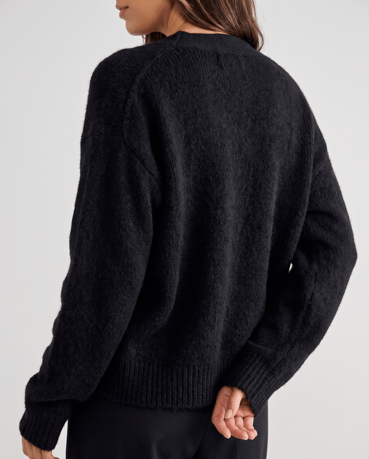 Back view of the black cardigan with ribbed hem and cuffs