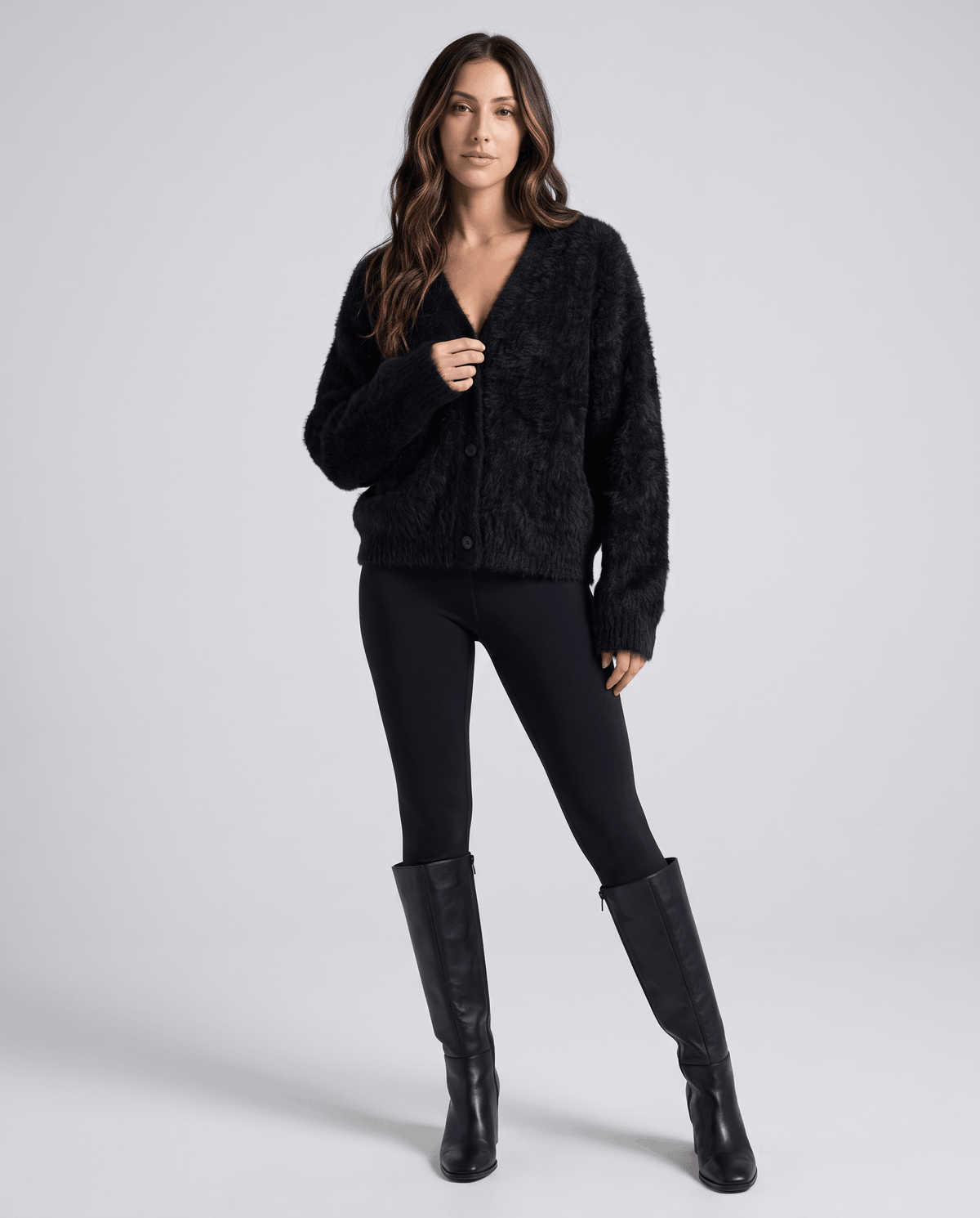 Full-length black cardigan outfit with black leggings and knee-high boots
