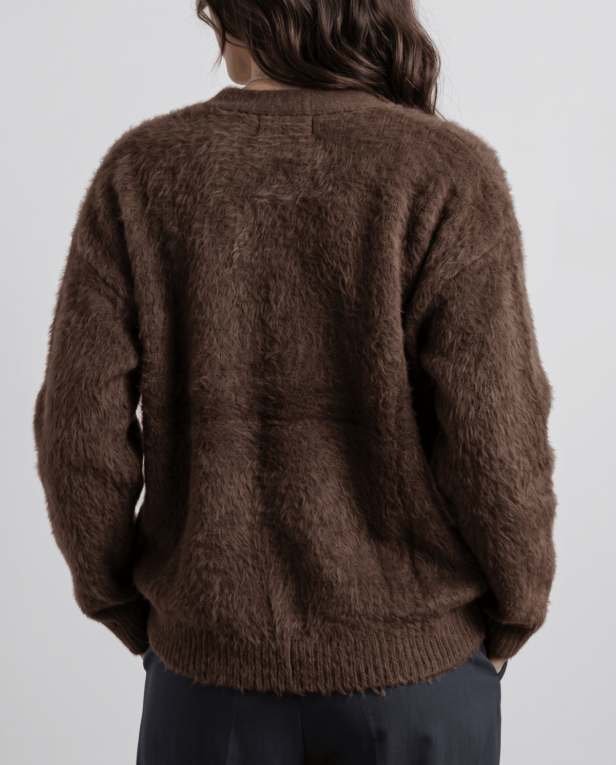 Back view of the brown cardigan showing the textured knit