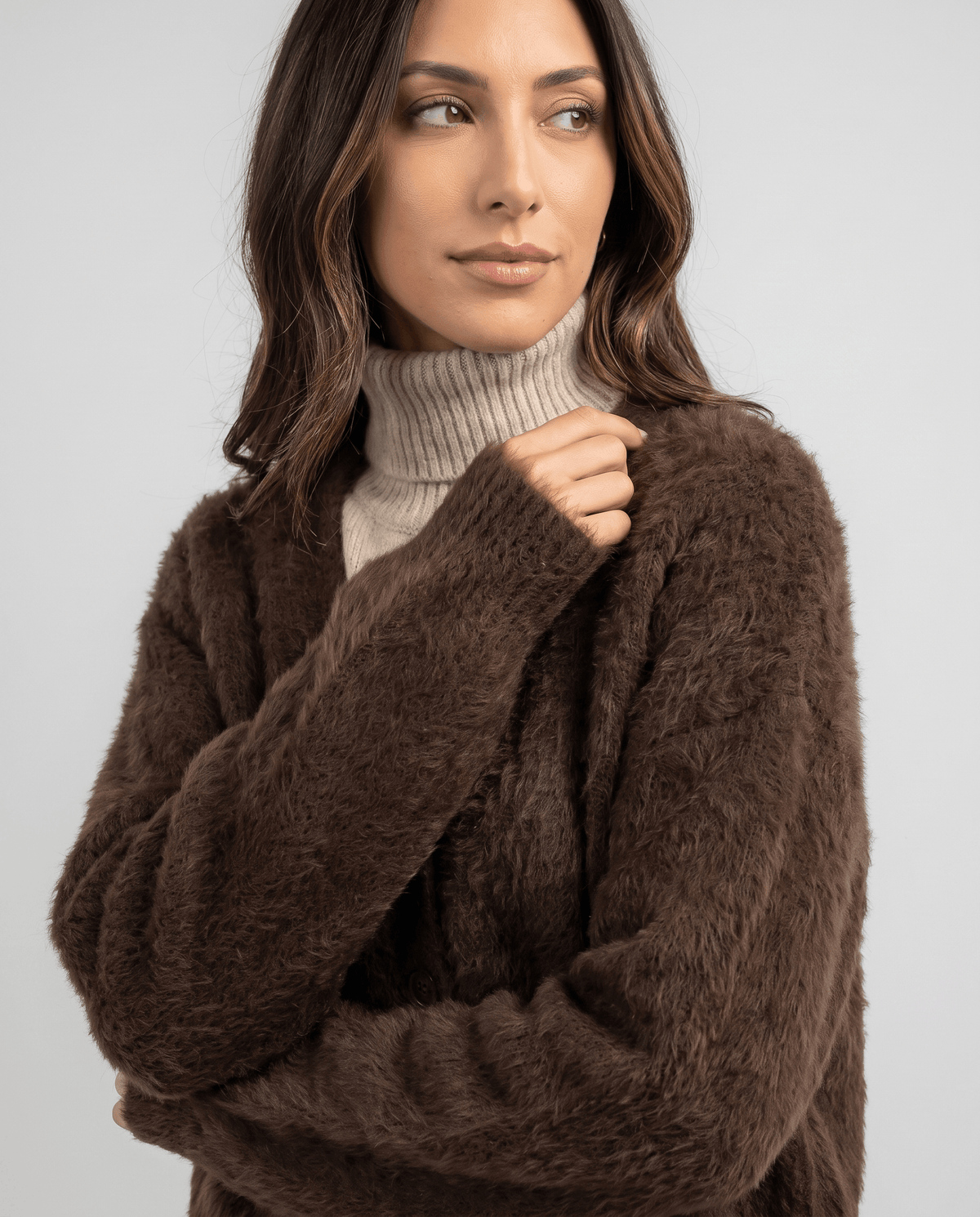 Close-up of the brown cardigan with arms crossed over the front