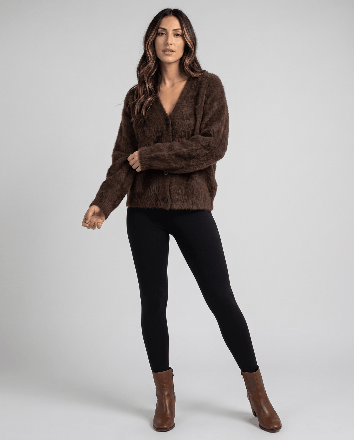 Full-length brown cardigan outfit with black leggings and brown ankle boots