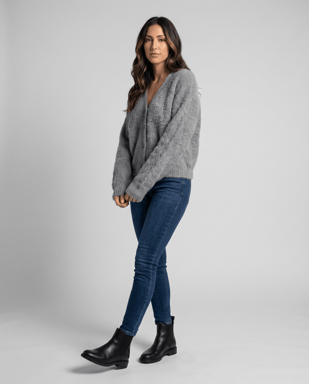Full-length light gray cardigan outfit with blue jeans and black ankle boots