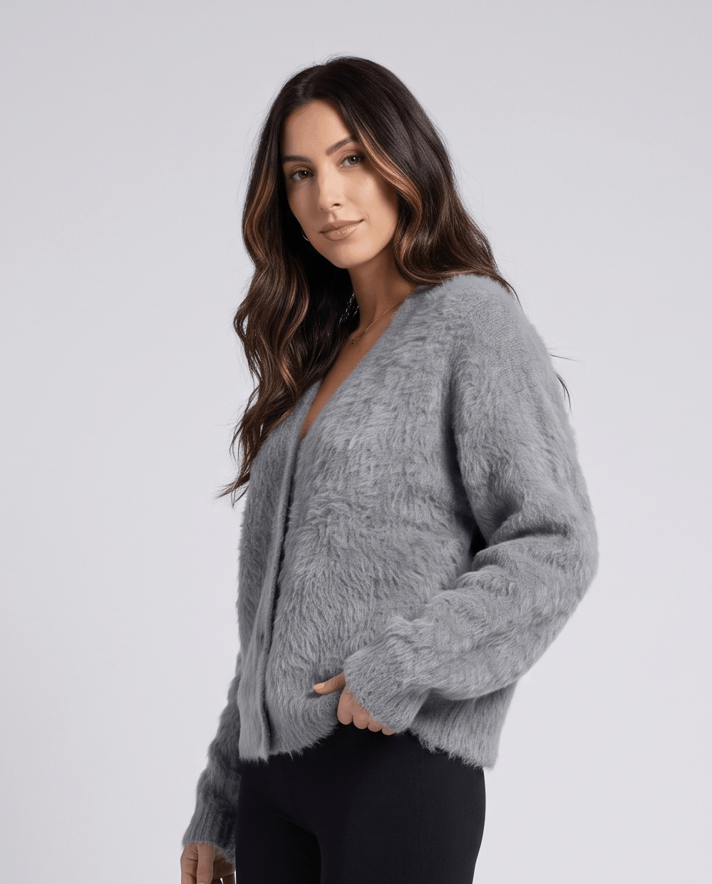 Side view of the light gray cardigan worn with black pants