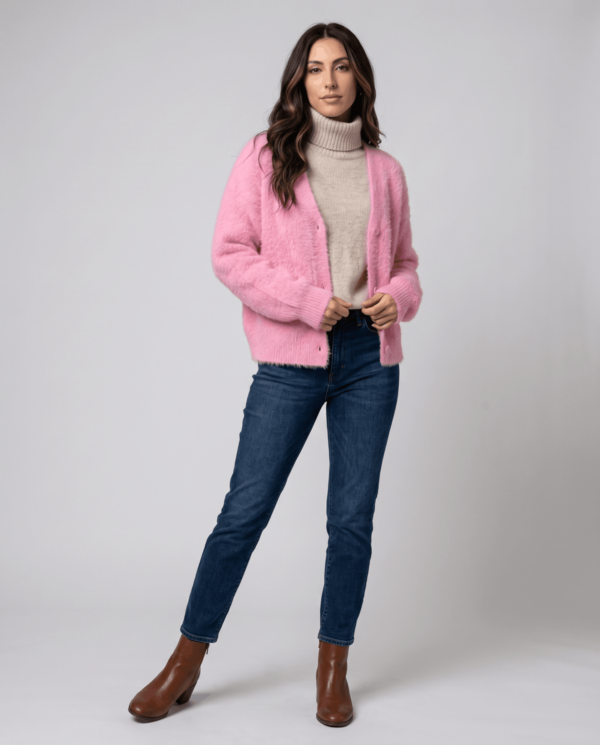 Full-length pink cardigan outfit with blue jeans and brown ankle boots
