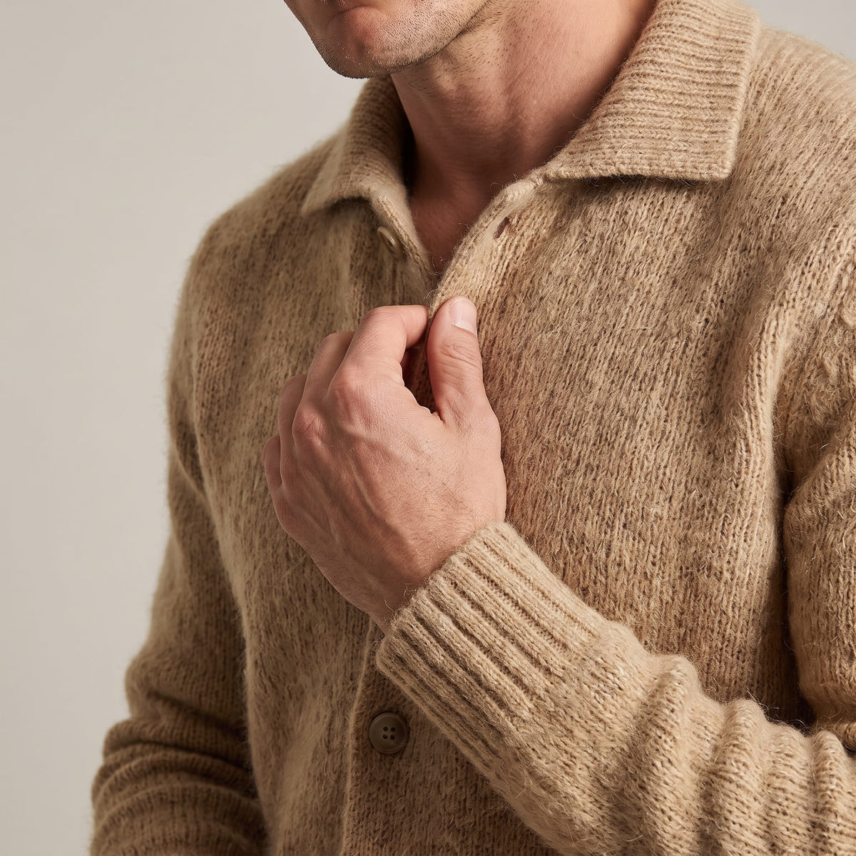 Close-up of the spread collar, buttons and ribbed cuff on the fuzzy brushed knit