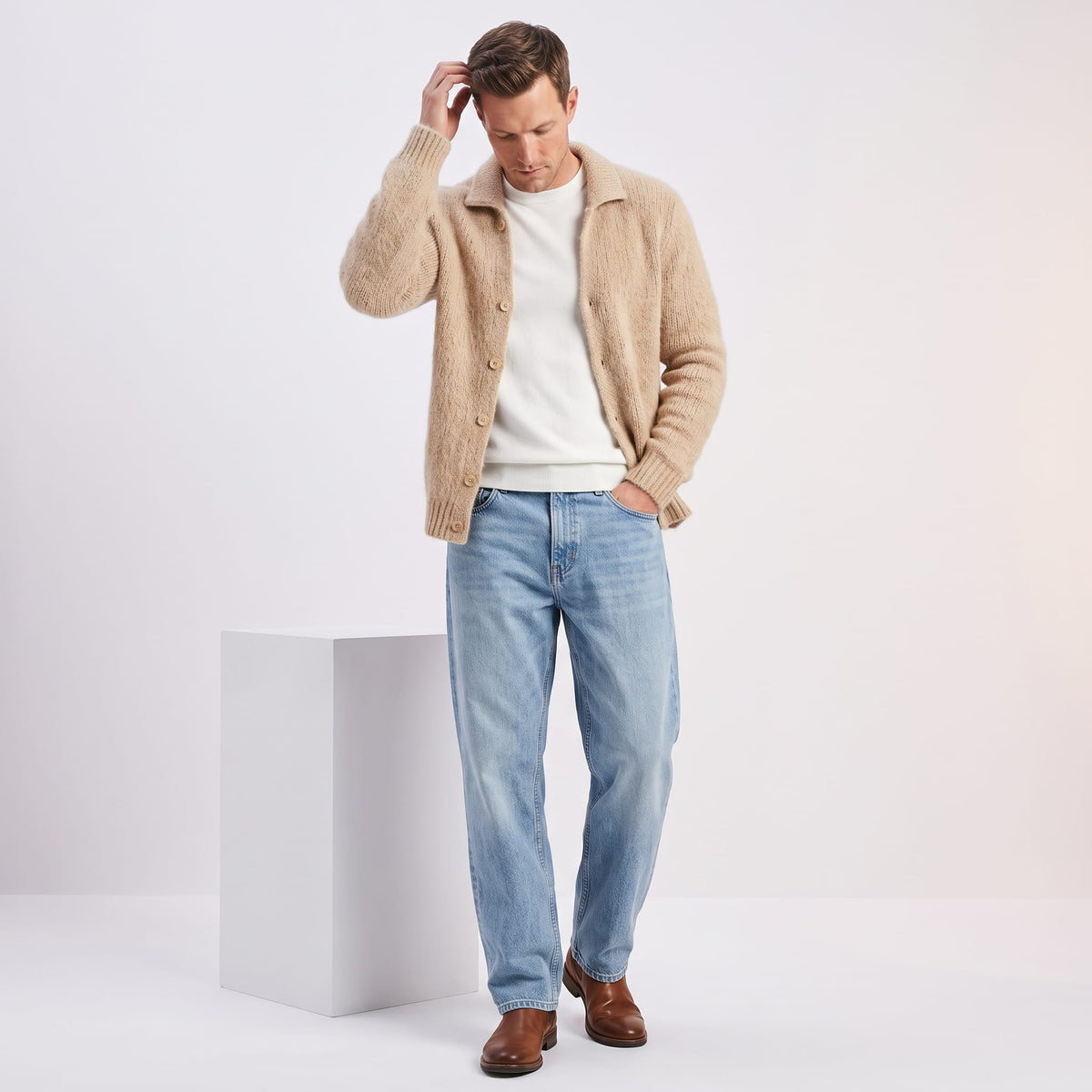 Khaki cardigan worn open over a white tee with light blue jeans and brown shoes