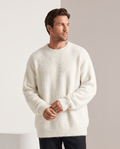 Men's fuzzy crew neck pullover sweater in white with hands clasped