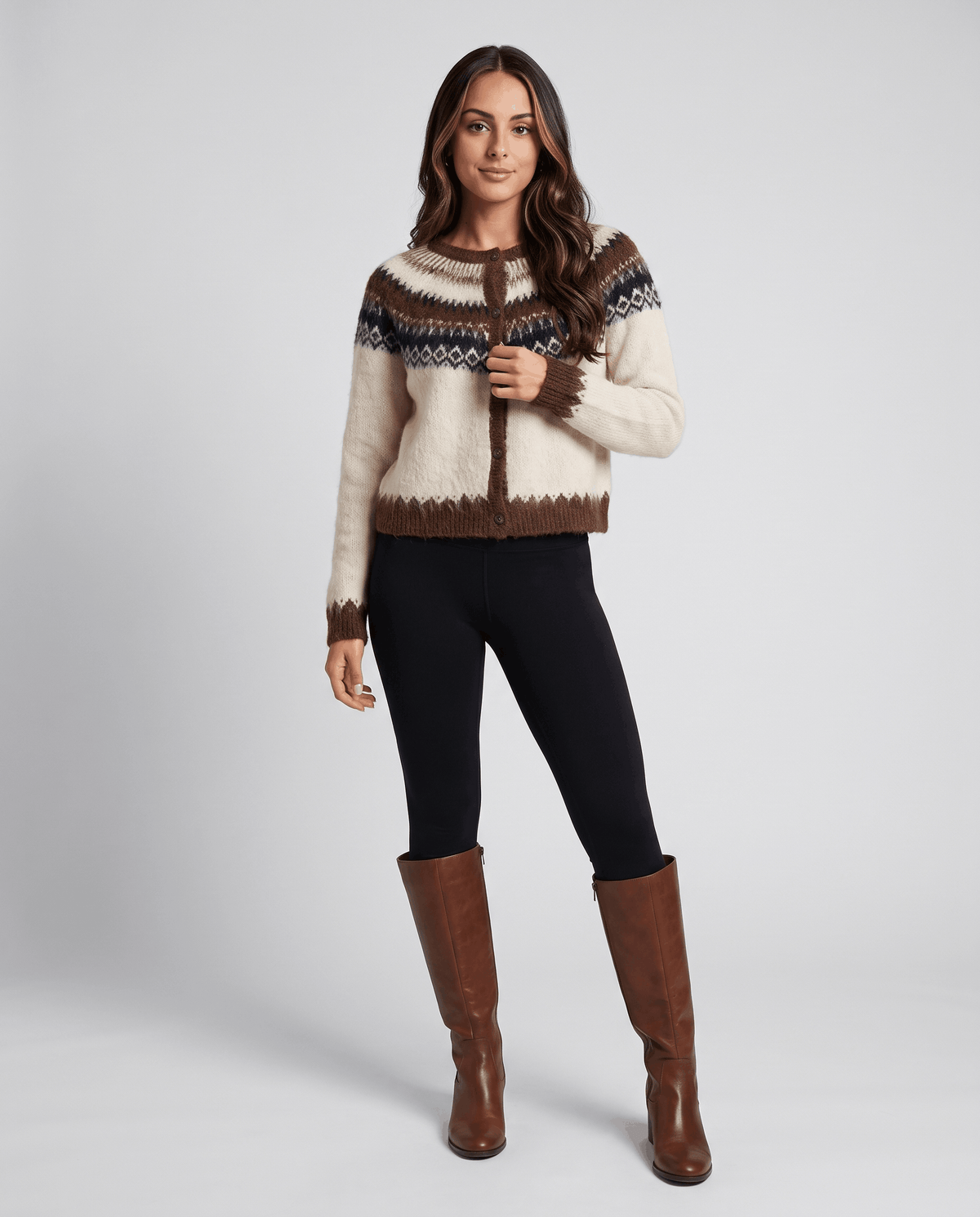 Full-length beige cardigan outfit with black pants and brown knee-high boots
