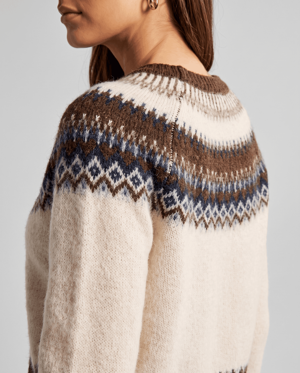 Detail of the brown and navy diamond yoke pattern across the shoulder