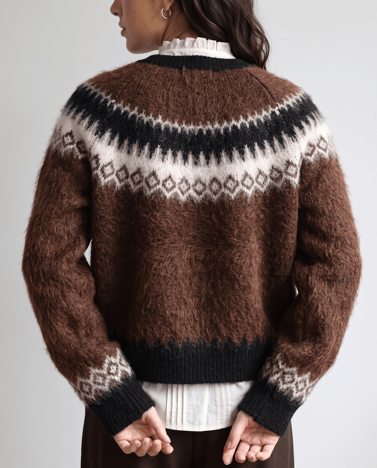 Back view of the brown cardigan with cream yoke pattern and black ribbed trim