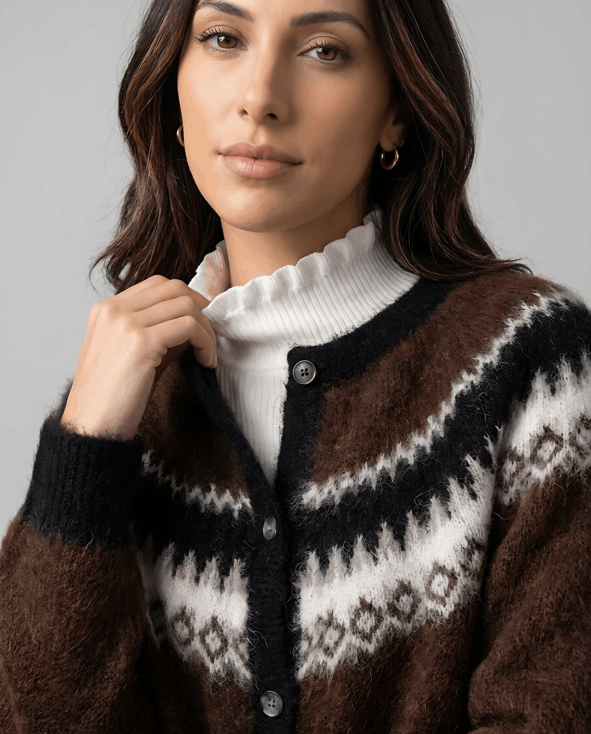 Close-up of the brown cardigan crew neck over a white turtleneck