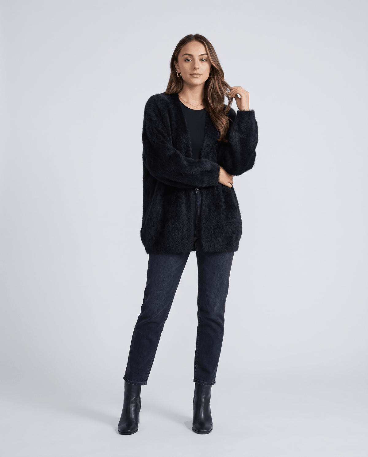 Full-length black cardigan outfit with dark jeans and black ankle boots