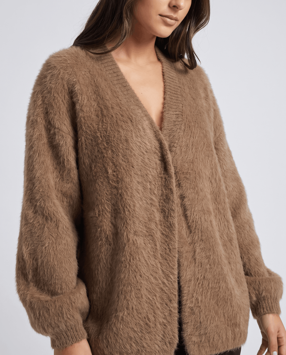 Front view of the brown cardigan showing its open front and ribbed cuffs