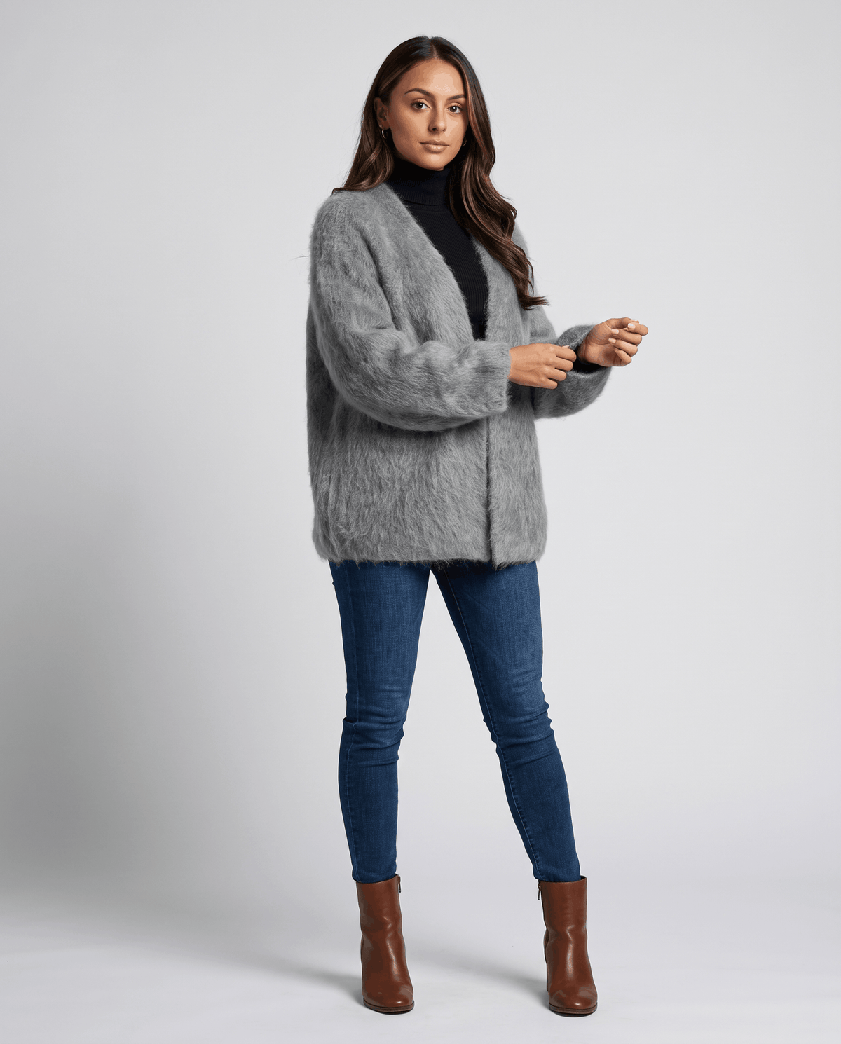 Full-length gray cardigan outfit with blue jeans and brown ankle boots