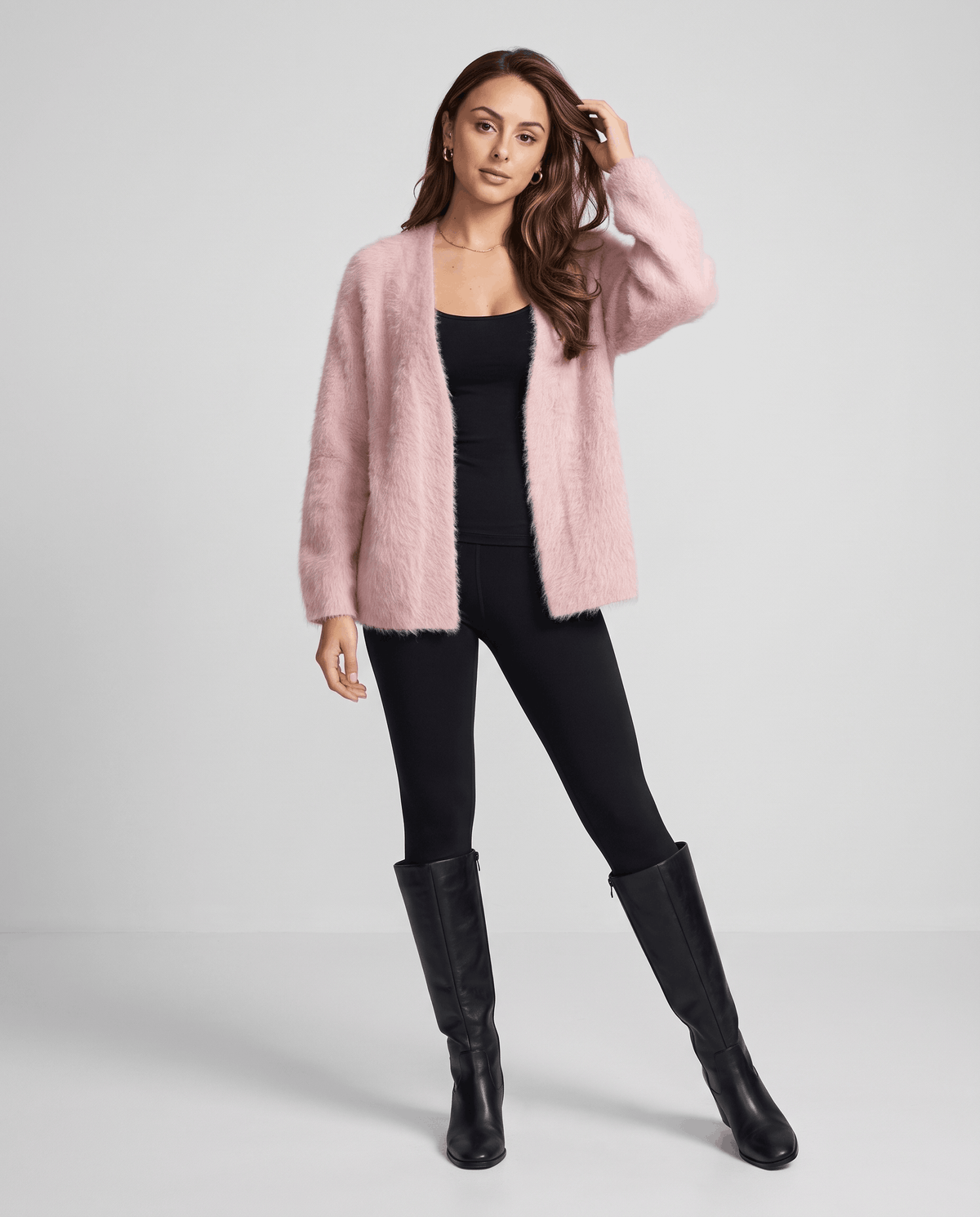 Full-length pink cardigan outfit with black leggings and black knee-high boots