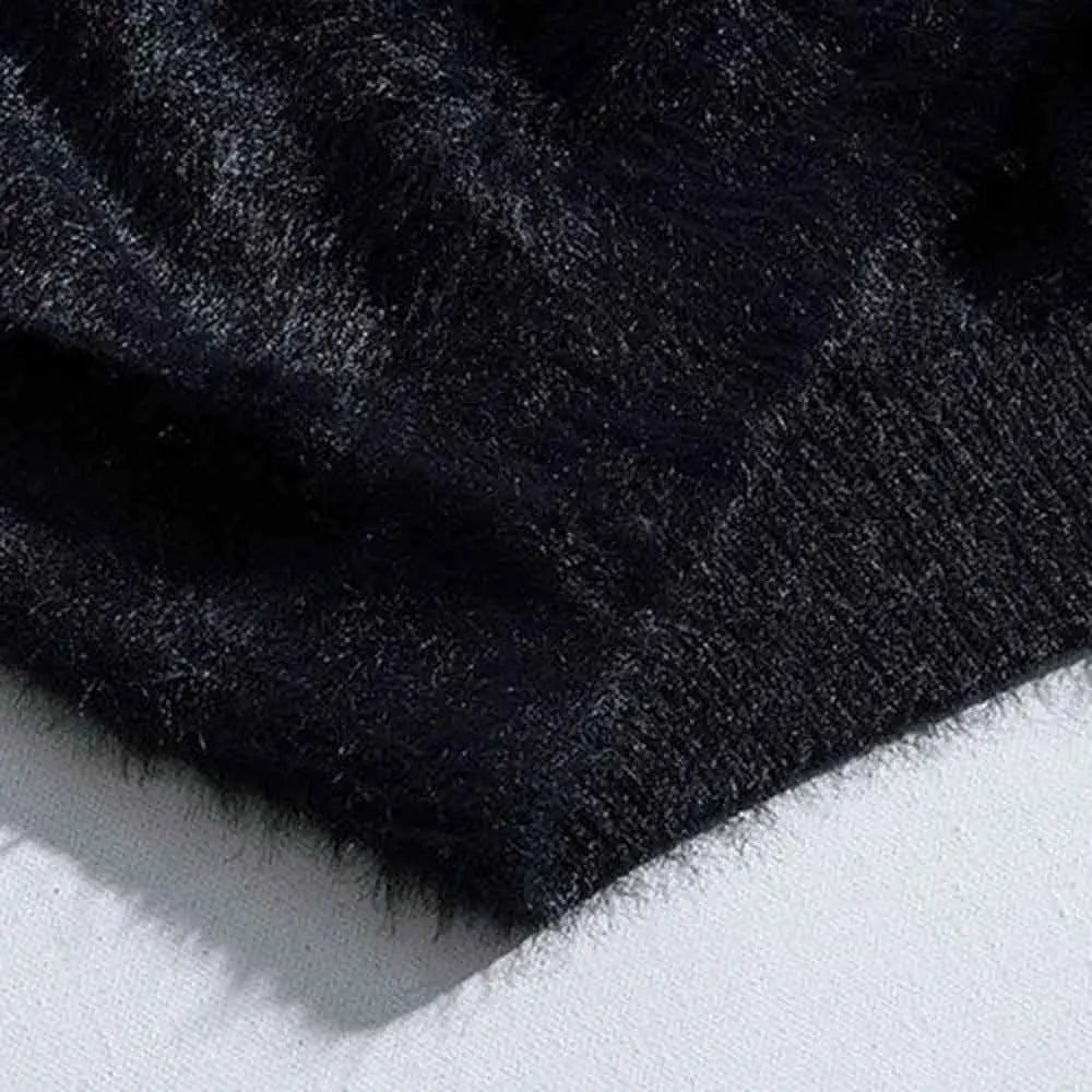 Close-up of the ribbed hem on the black fuzzy knit cardigan