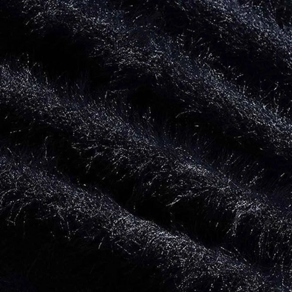Macro view of the black cardigan's long-pile fuzzy knit texture