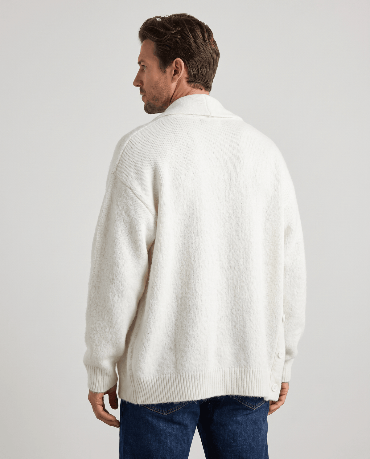 Back view of the white relaxed-fit cardigan with ribbed cuffs and hem