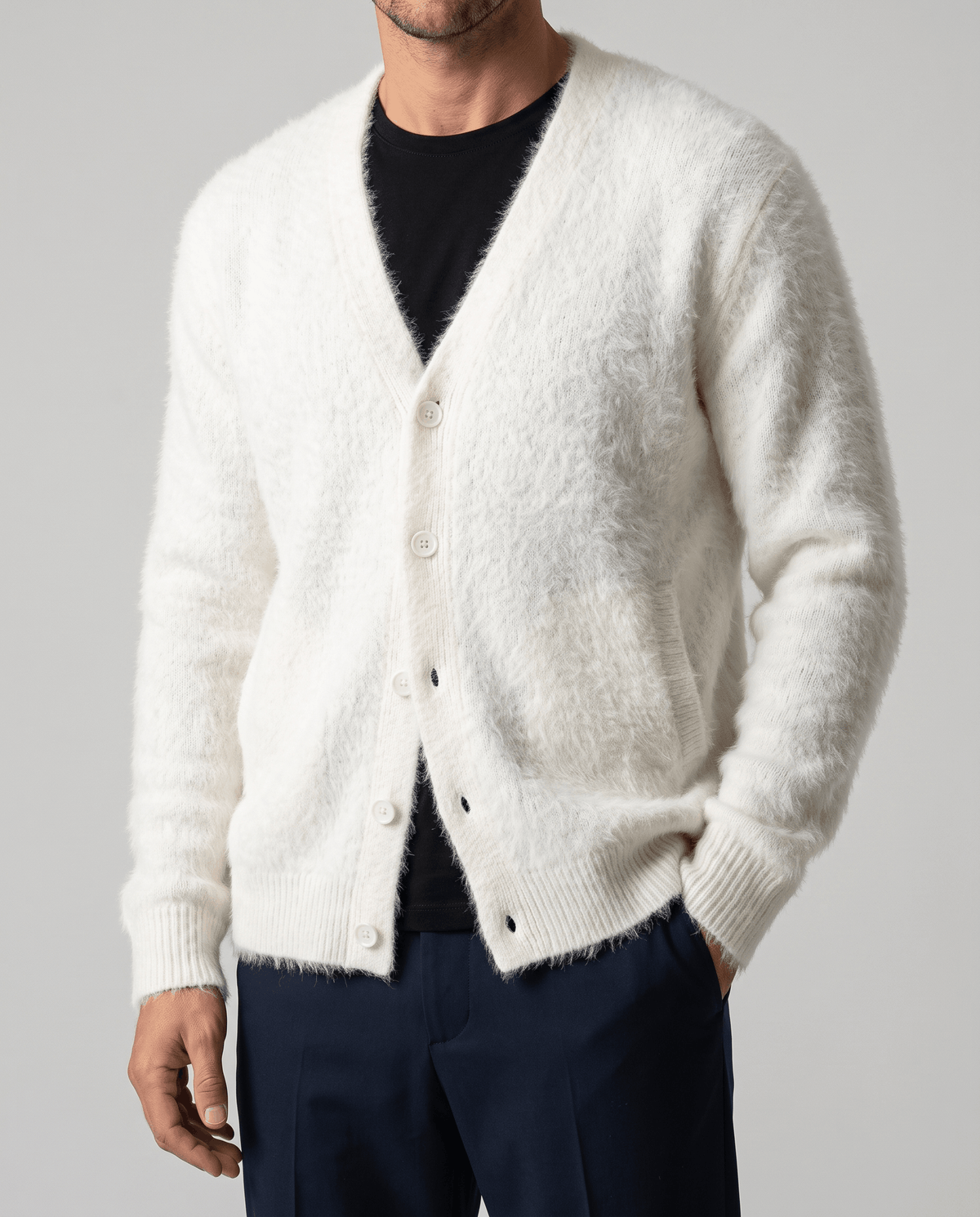 Front close-up of the white knit cardigan buttoned over a black tee