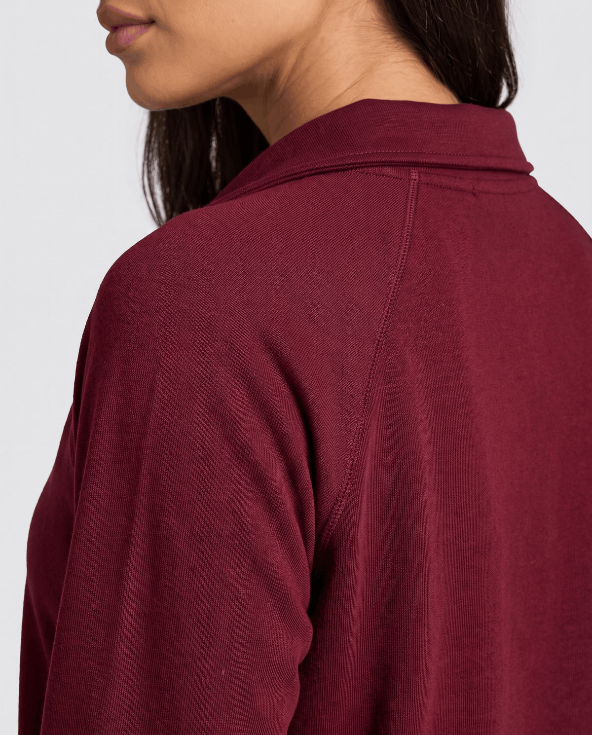 Close-up of burgundy fold-down collar and raglan shoulder seam