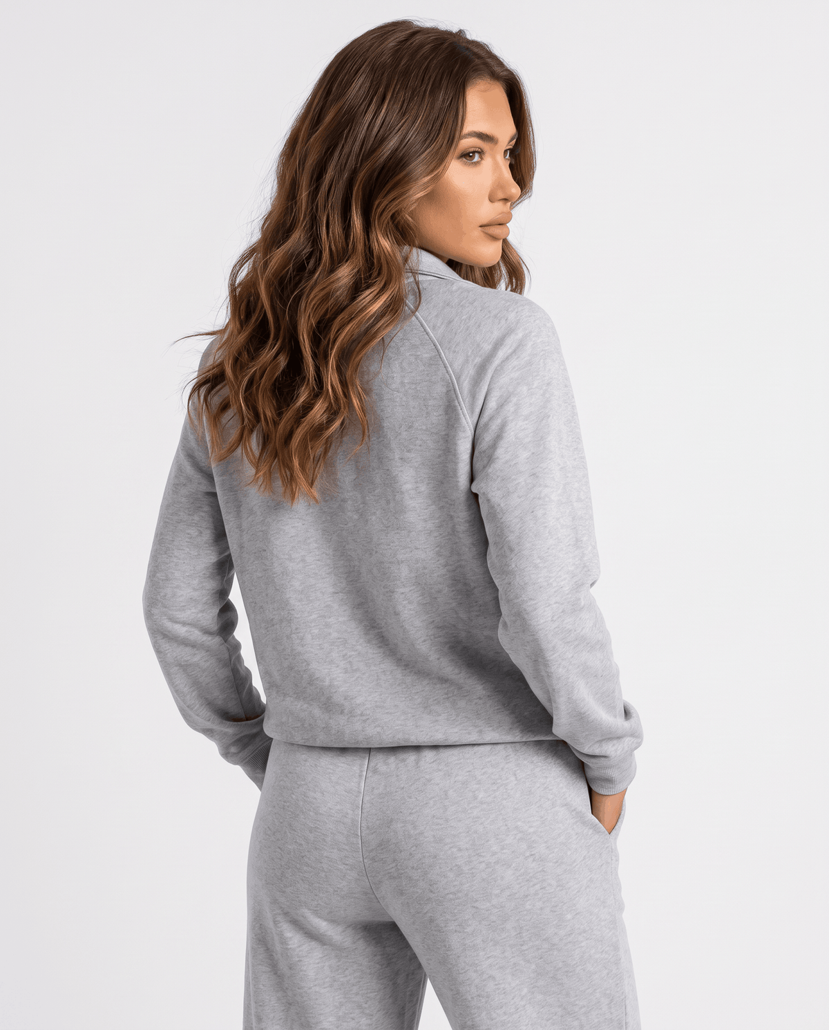 Back view of gray half-zip top with raglan sleeves worn over gray pants