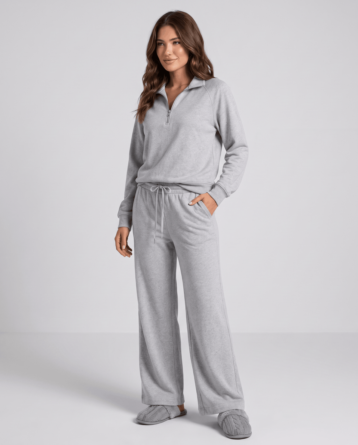 Woman in a gray half-zip top and wide-leg pants, full-length front view