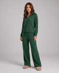 Woman in a green half-zip lounge set with wide-leg pants, full-length front view