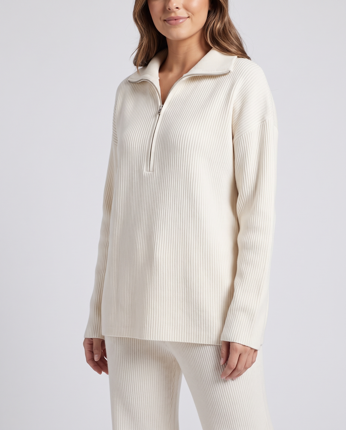 Beige ribbed knit pullover with a half-zip front and folded collar, three-quarter view