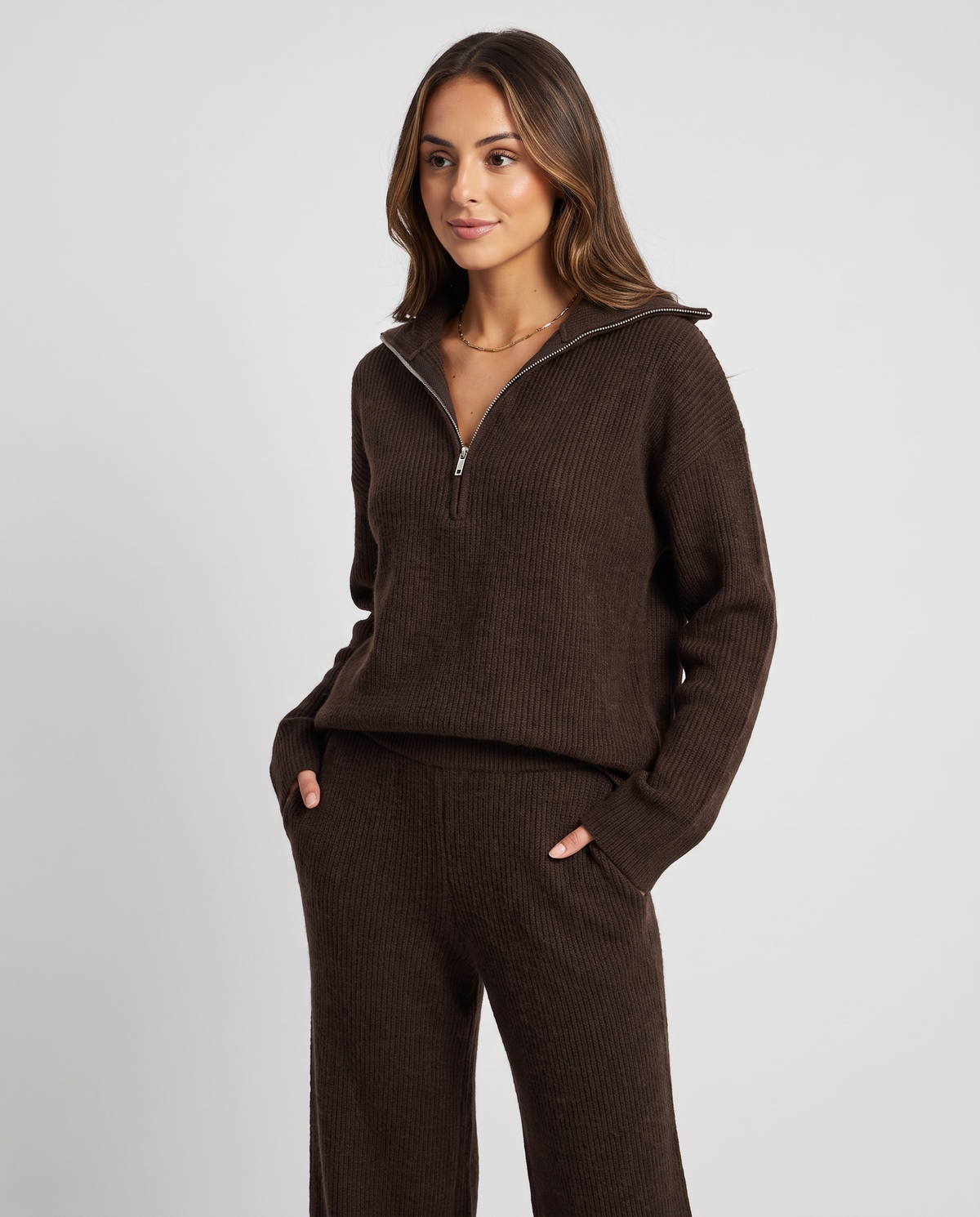 Dark brown half-zip pullover styled with one hand in the wide-leg pants pocket