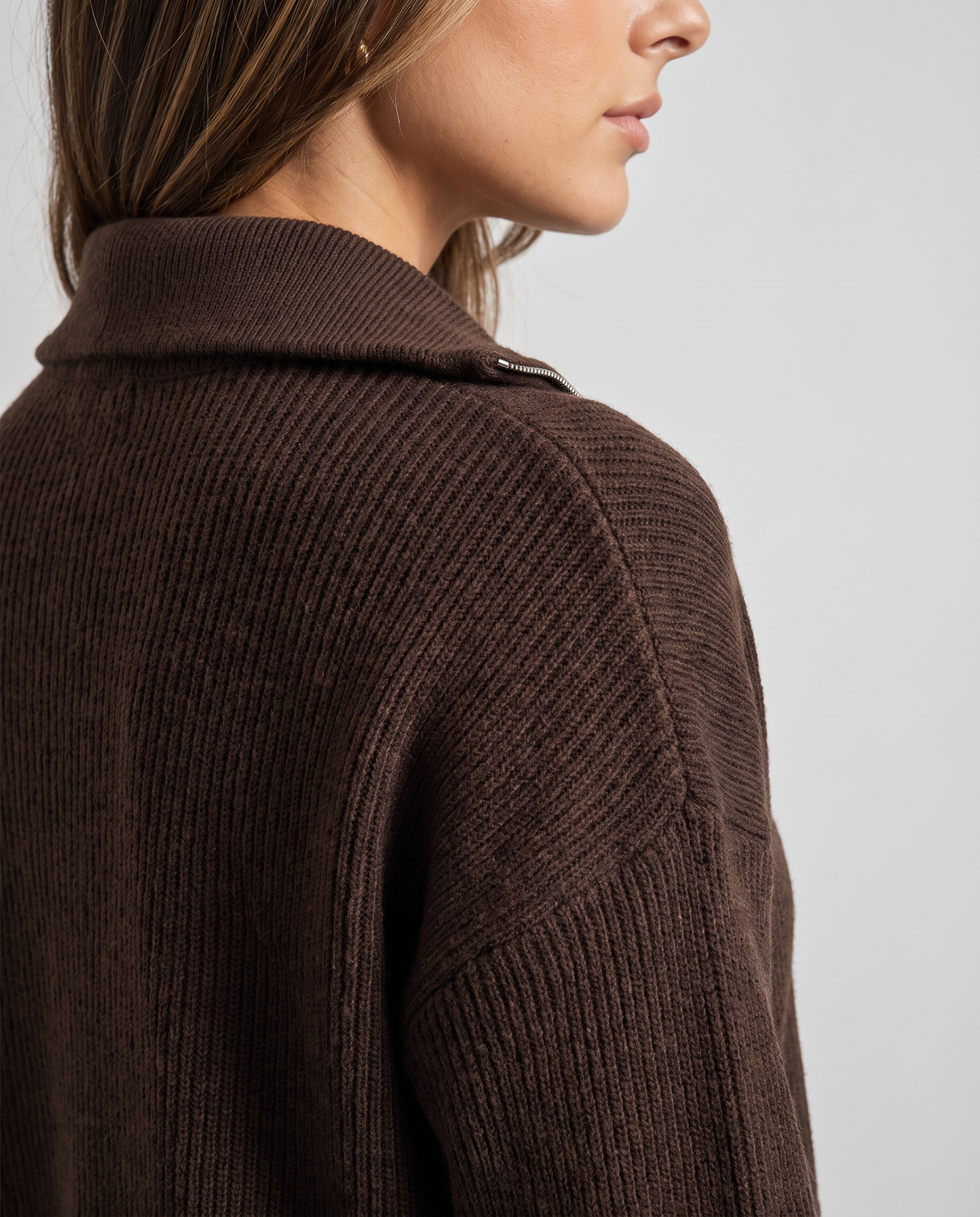 Close-up of the ribbed knit shoulder and collar on the dark brown pullover