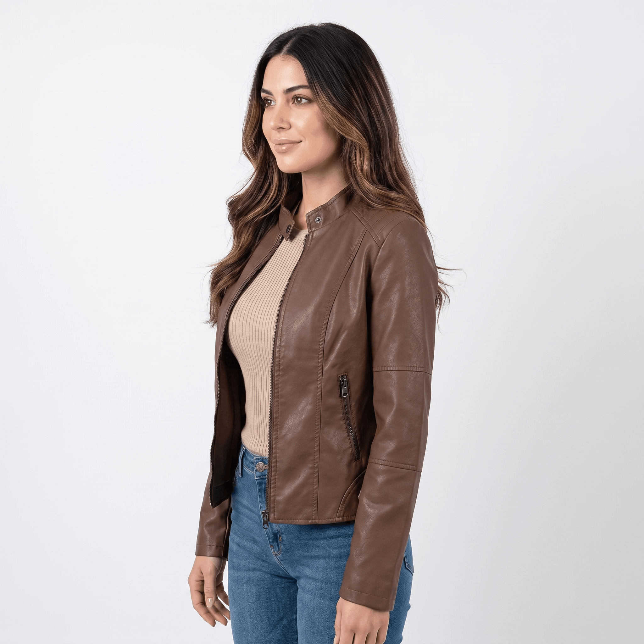 Side view of a woman wearing a brown faux leather jacket with a sleek fitted silhouette and zip-front closure.
