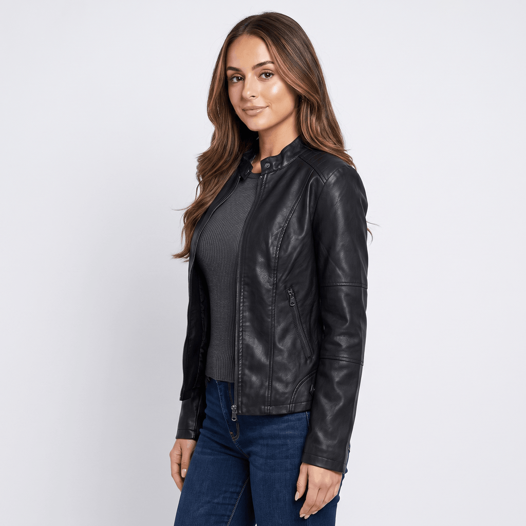 Side view of a woman wearing a black faux leather jacket featuring a zip-front closure, long sleeves, and a tailored fit.