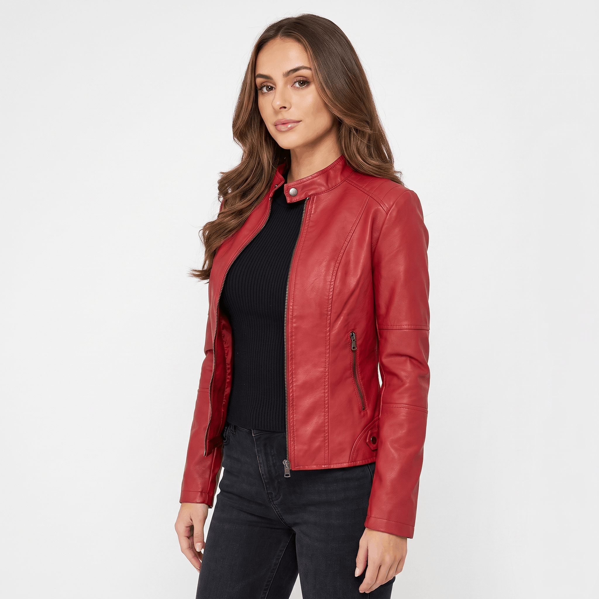Three-quarter view of a woman wearing a red faux leather jacket featuring a fitted silhouette and smooth faux leather finish.