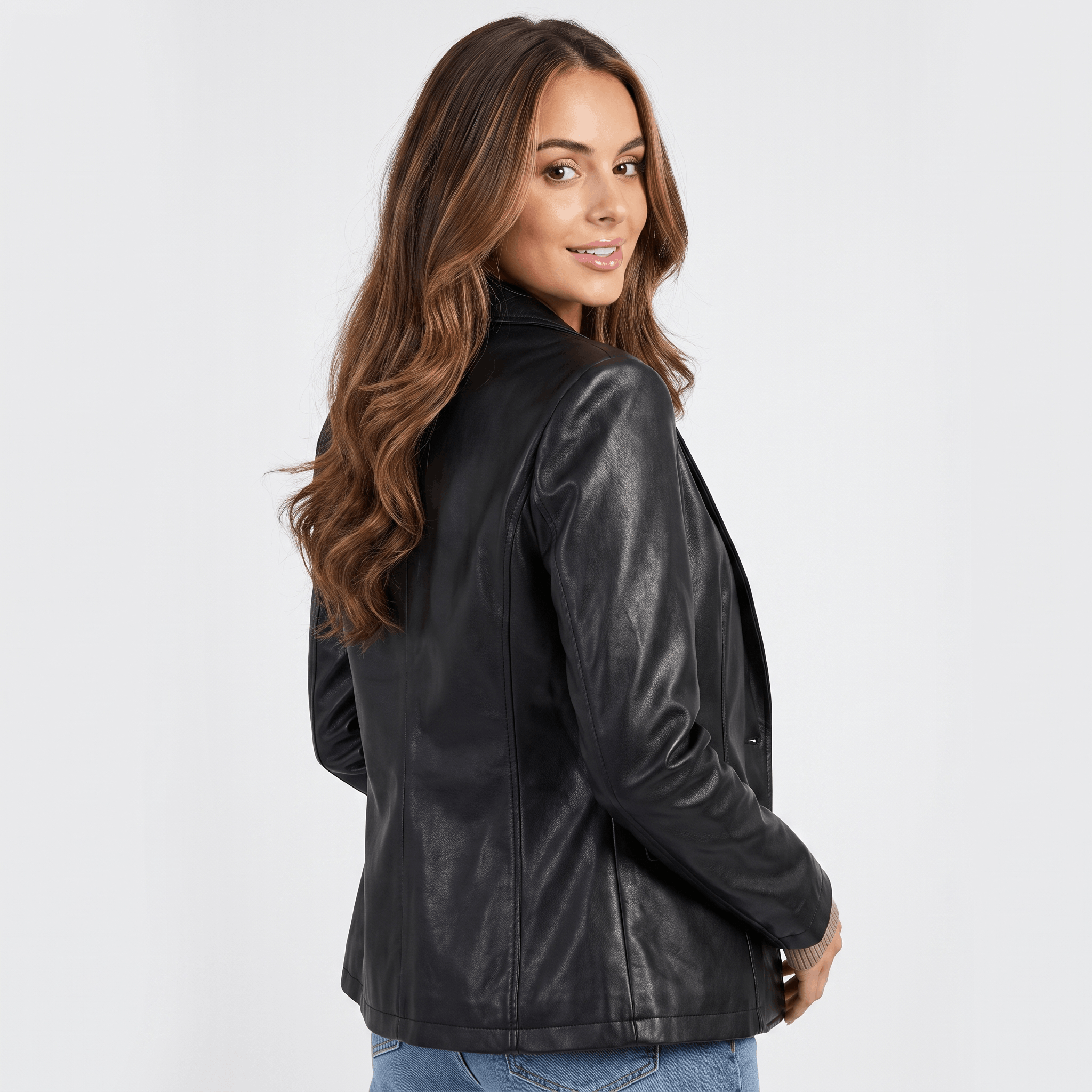 Side view of a women's black faux leather blazer featuring a fitted silhouette, notched lapel, and long sleeves.