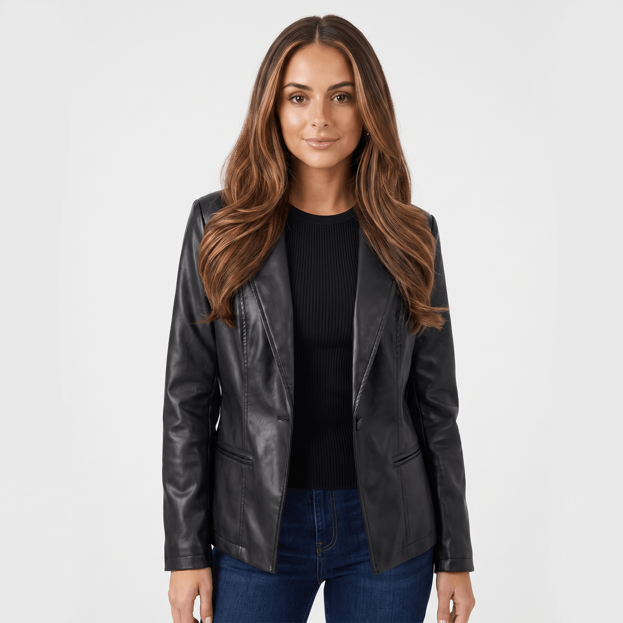 Woman wearing a black faux leather blazer with a notched lapel, single-button closure, and fitted silhouette over a black top.