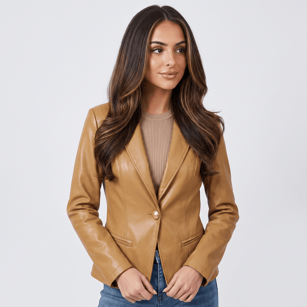 Front view of a women's camel faux leather blazer featuring a tailored fit, single-button closure, and flap pockets.