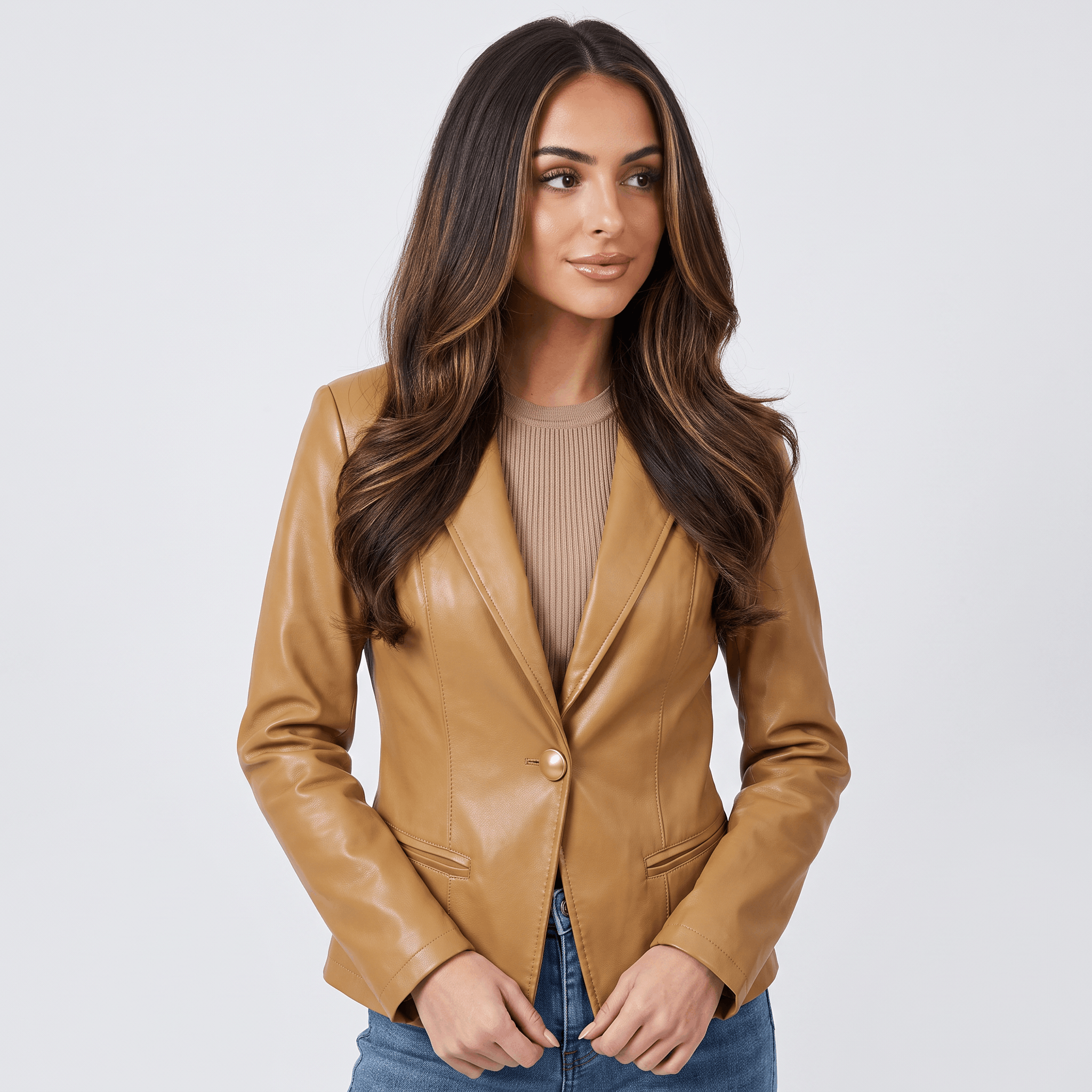 Front view of a women's camel faux leather blazer featuring a tailored fit, single-button closure, and flap pockets.