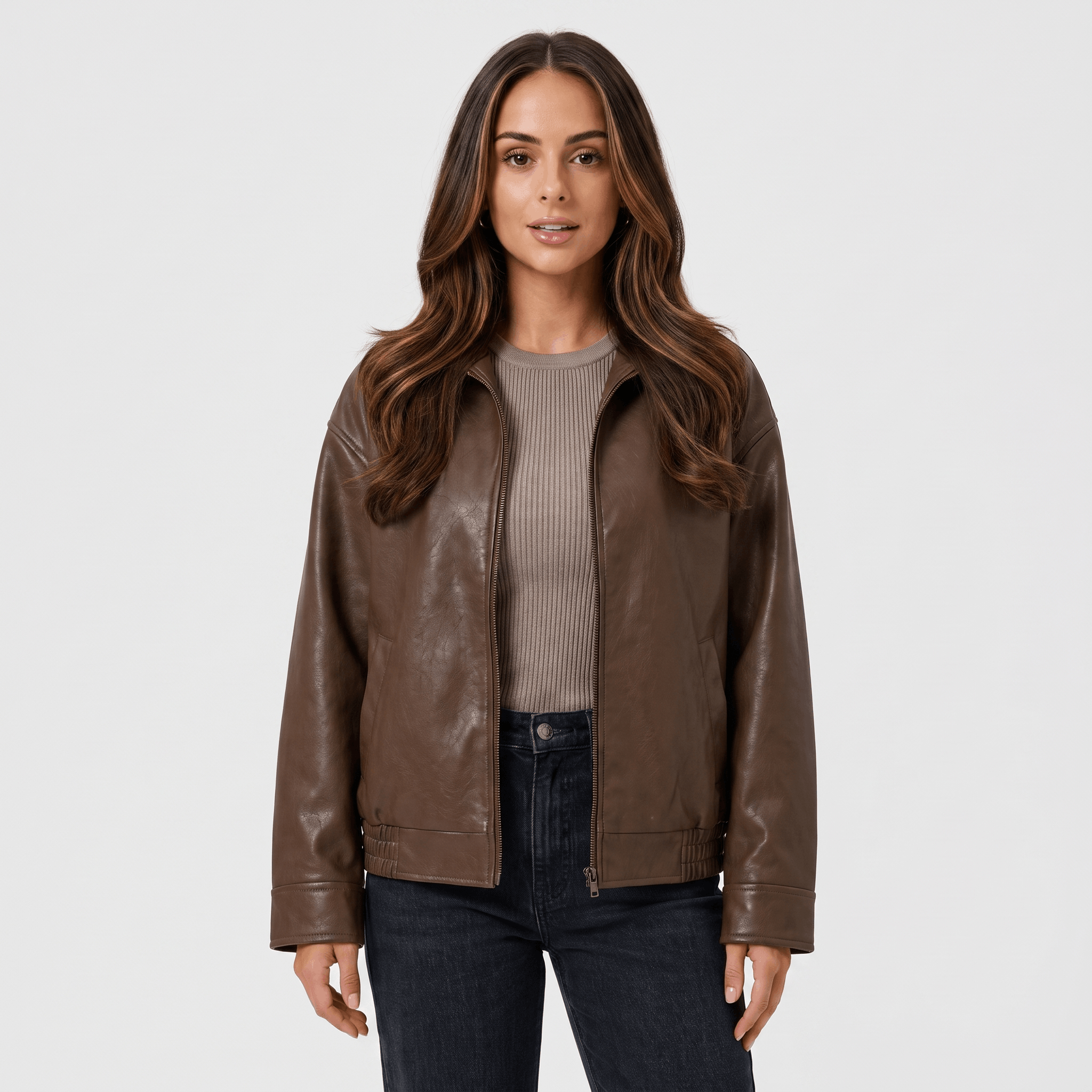 Front view of a woman wearing a brown faux leather jacket featuring a zip-front closure, classic collar, and smooth leather-look finish.