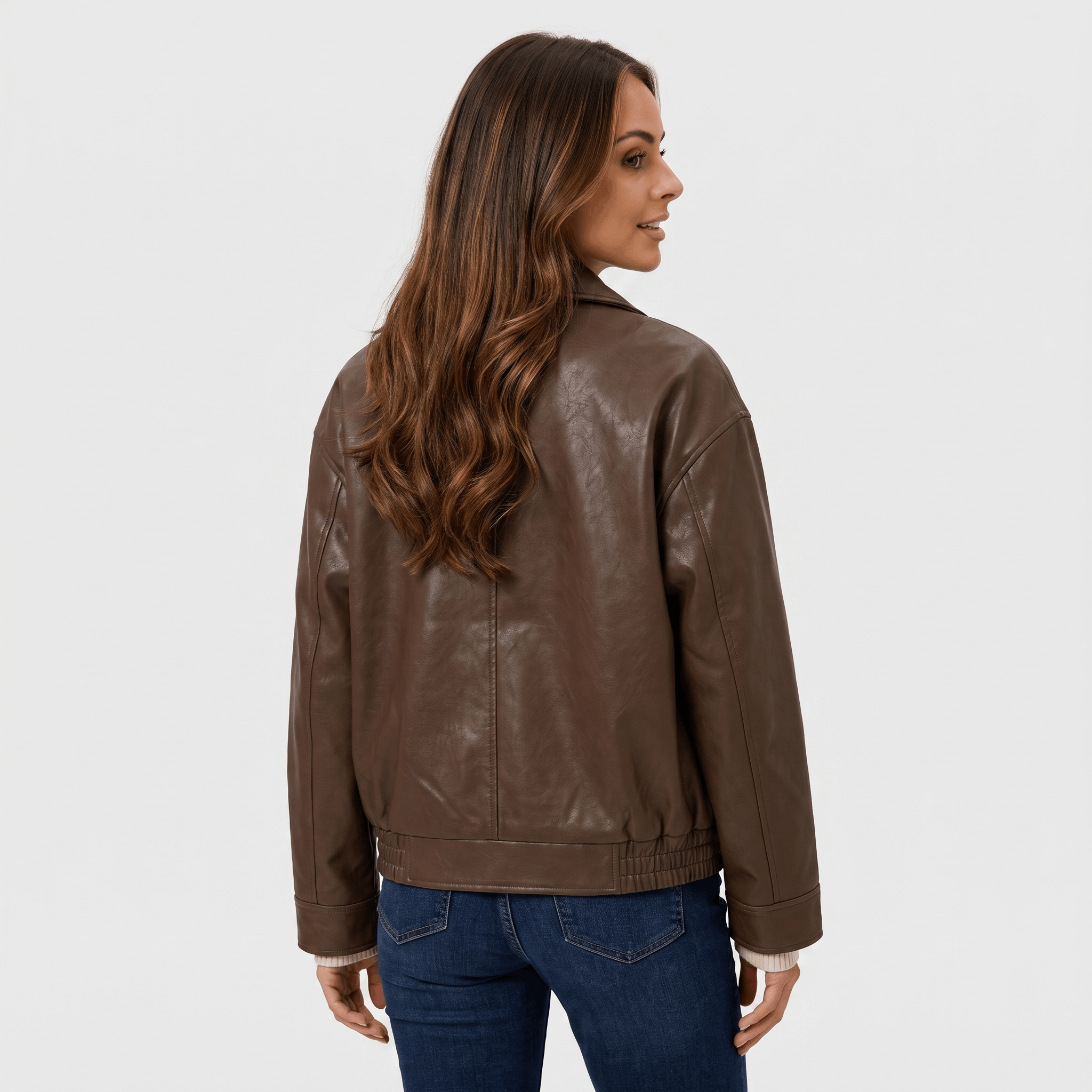 Back view of a women's brown faux leather jacket with a straight-fit silhouette, long sleeves, and clean minimalist design.