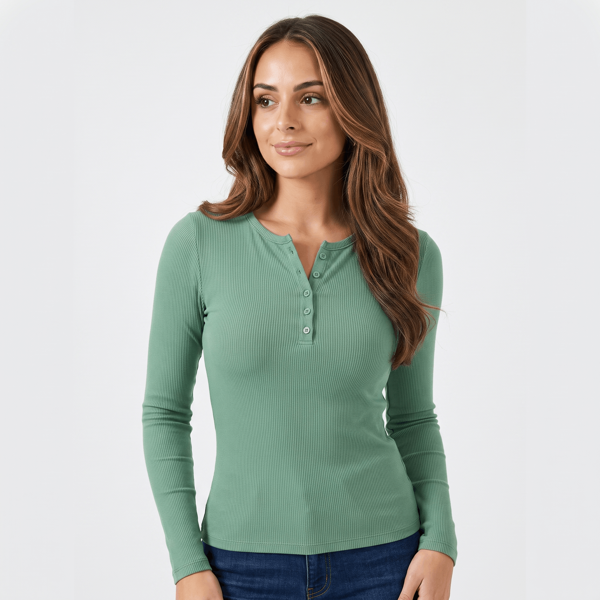 Woman wearing a green ribbed henley top with a button neckline, long sleeves, and fitted silhouette.